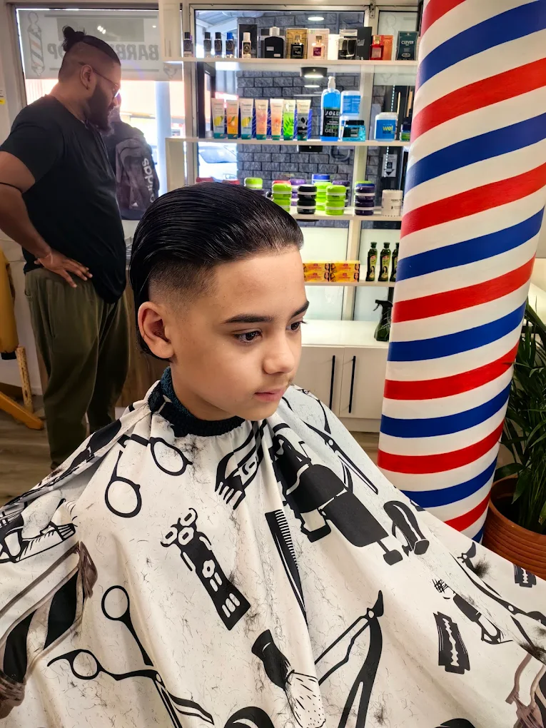 Young boy getting a fresh haircut at the barbershop